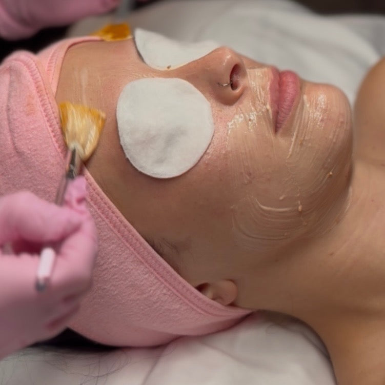 painting on a masque during a custom eminence facial 